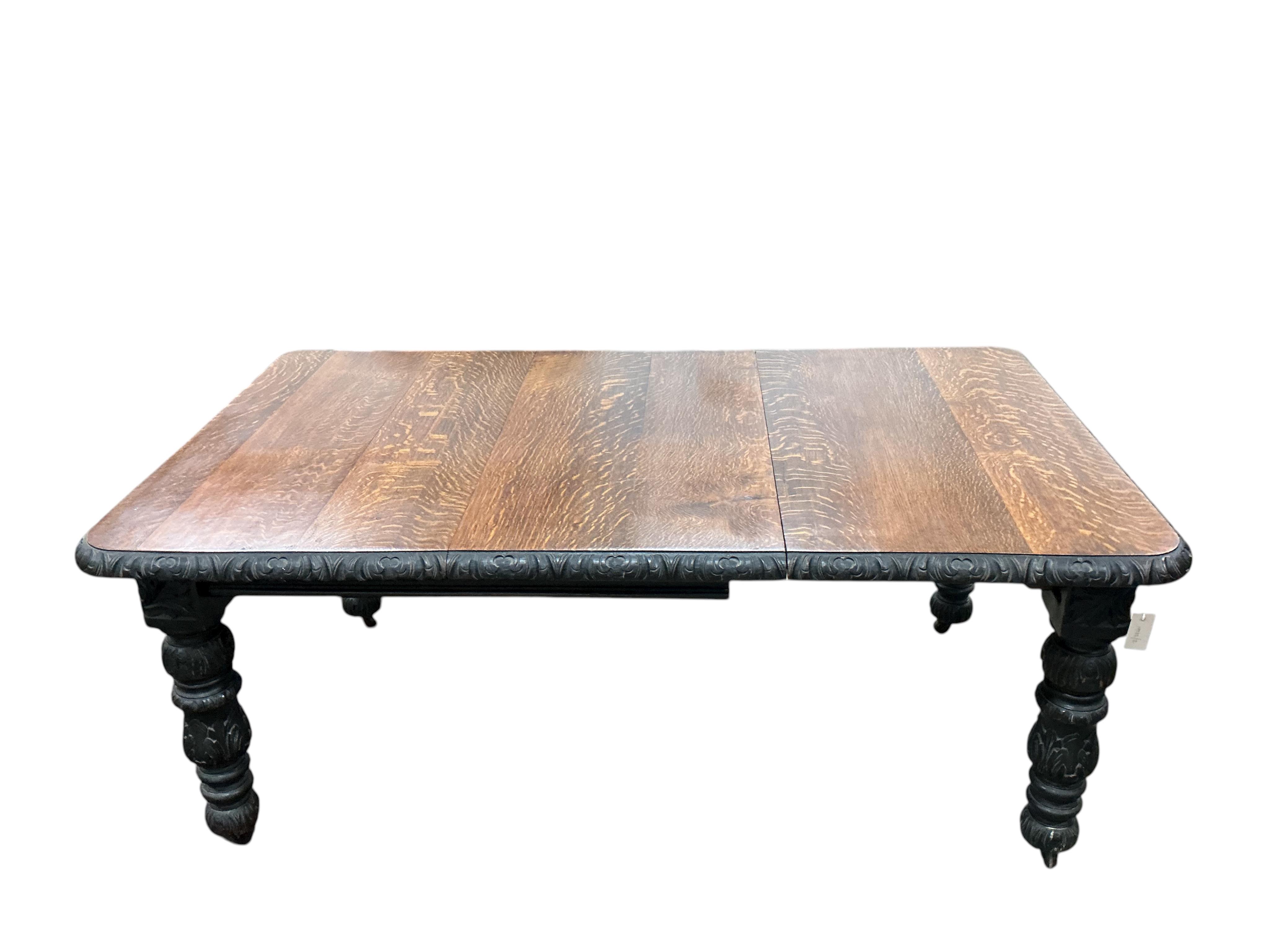 A late Victorian carved oak extending dining table, width 176cm extended, one spare leaf, depth 104cm, height 73cm